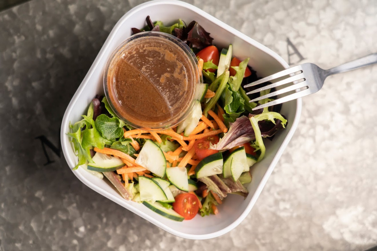 Mixed salad, red dip on the side